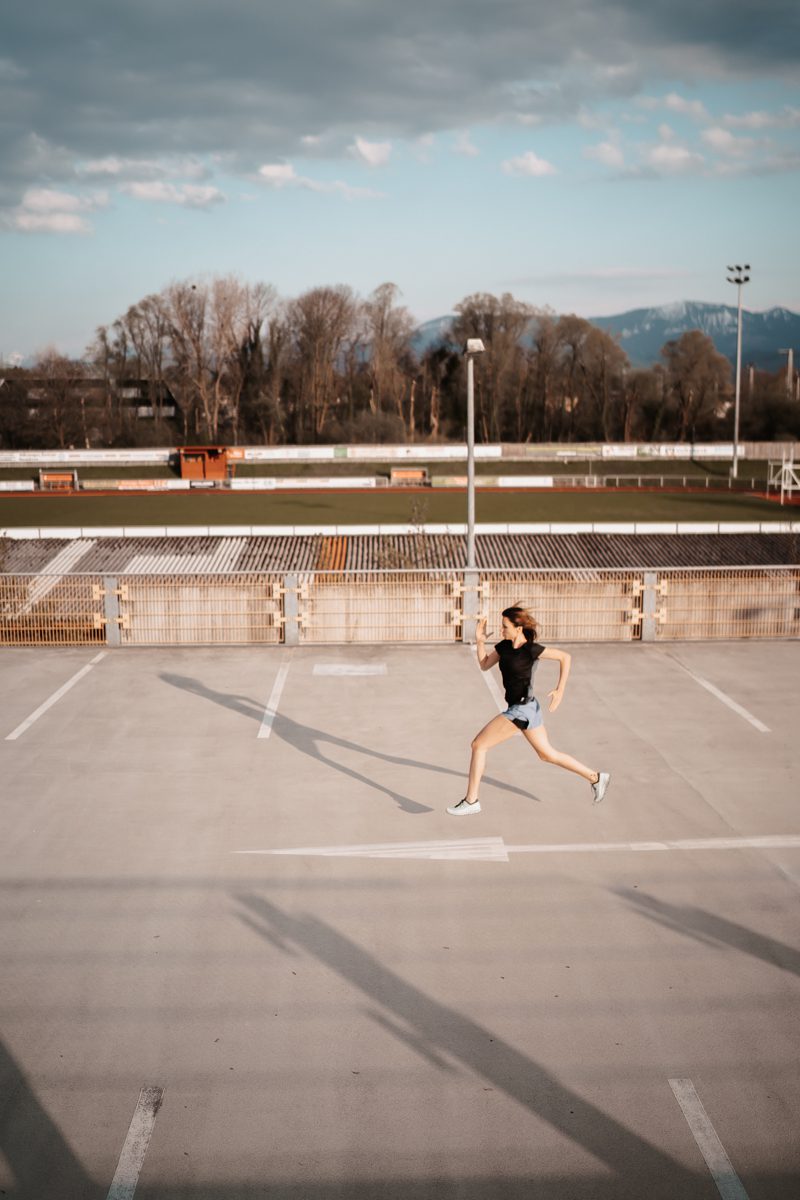 a woman running on a parking lot