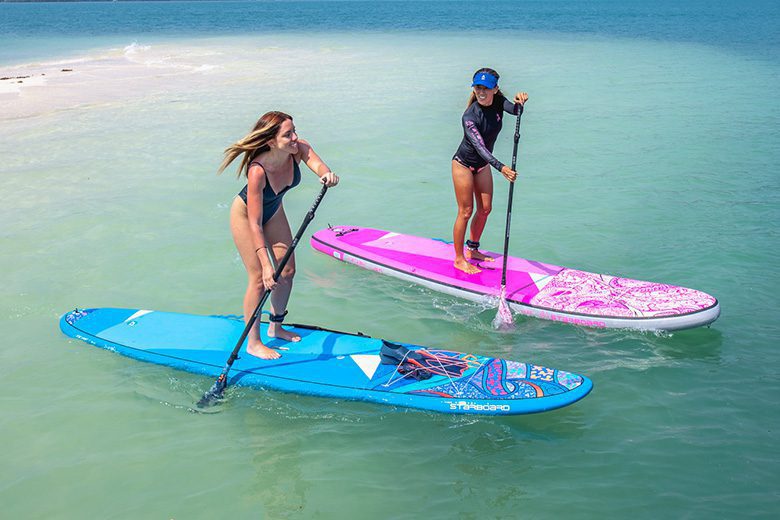 two women on paddle boards in the water